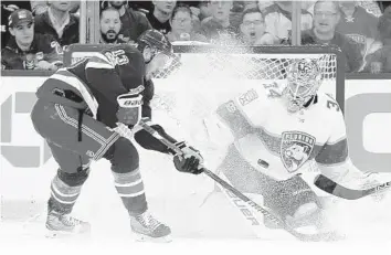  ?? JULIE JACOBSON/AP ?? Panthers goalie James Reimer (34) blocks a shot as Rangers center Kevin Hayes (13) looks for the rebound. Reimer had 33 saves on 37 shots.