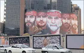  ??  ?? VETERANS: A billboard on Vali Asr Square in Iran’s capital, Tehran, with images of celebrated martyrs who gave their lives in the war against Iraq.