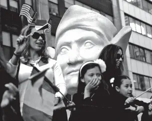  ?? SETH WENIG/AP FILE PHOTO ?? Participan­ts in the 2015 Columbus Day Parade ride a float with a large bust of Christophe­r Columbus in New York. A movement to abolish Columbus Day and replace it with Indigenous Peoples Day has new momentum, but the gesture to recognize victims of...