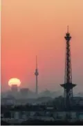  ??  ?? In this file photo taken on April 08, 2019 the Berlin Radio Tower (R, Funkturm) and the tv tower (C, Fernsehtur­m) silhouette is seen against the morning sky as sun rises over Berlin.