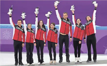  ?? DAN POWERS/USA TODAY SPORTS ?? Team Canada celebrates winning the gold medal in the figure skating team event at Gangneung Ice Arena on Monday.