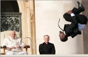  ?? ?? Pope Francis looks at an acrobat of the Black Blues Brothers performing during his weekly general audience in St. Peter’s Square in Rome, Italy