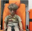  ?? PHOTO: REUTERS ?? Five-year-old Omran Daqneesh, with bloodied face, sits inside an ambulance after he was rescued following an airstrike in the rebel-held al-qaterji neighbourh­ood of Aleppo.