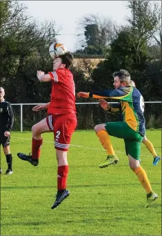  ??  ?? Alex Cameron of Enniskerry beats Chris Maher to the header.