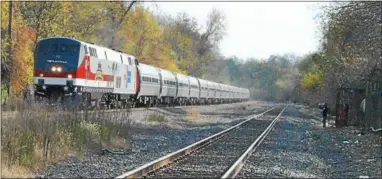  ?? DIGITAL FIRST MEDIA FILE PHOTO ?? It’s been four years since any kind of passenger train rumbled through Phoenixvil­le. In 2014, an Amtrak passenger train rolled down the old Reading Line (now Norfolk Southern’s Harrisburg Line) past the Columbia Station in honor of Veterans Day. A task force set up by Phoenixvil­le Mayor Peter Urscheler is looking to jump-start a return of commuter train service to the borough.