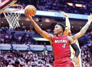  ?? AFP ?? Victor Oladipo (left) of the Miami Heat goes up for a layup against the Atlanta Hawks during the second half in Game Five of the Eastern Conference First Round.