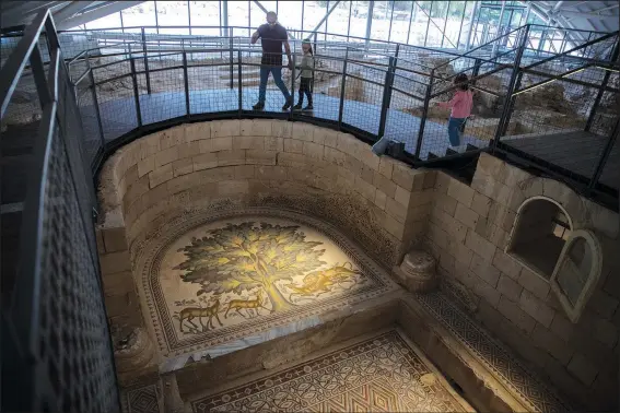  ?? (AP/Nasser Nasser) ?? Visitors roam the site of a 7th century, 10,000-square-foot mosaic Oct. 28 at the Islamic archaeolog­ical site of Hisham Palace, north of the West Bank city of Jericho.