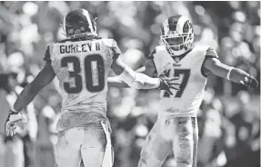  ?? KELVIN KUO/USA TODAY SPORTS ?? Running back Todd Gurley II celebrates after a two-point conversion with Robert Woods during the victory that lifted the Rams to 2-0.