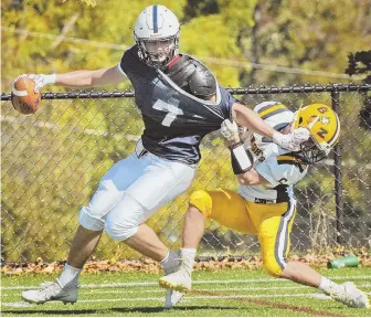  ?? STAFF PHOTOS BY PATRICK WHITTEMORE ?? BREAKAWAY THREATS: Lawrence Academy’s Joseph Luchetti fends off would-be tackler Michael Bulman of Buckingham Browne & Nichols yesterday. At left, LA’s Joshua Arruda sheds BB&N’s Tommy Maloney en route to a touchdown.