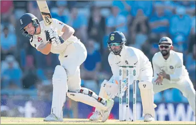  ??  ?? Rishabh Pant looks on as England batsman Jos Buttler drives yesterday