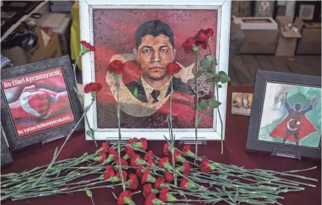  ?? CHRIS MCGRATH, GETTY IMAGES ?? Flowers surround a painting of a man killed on July 15, 2016. The country will mark the anniversar­y of the failed coup this weekend with ceremonies across Turkey. Others have been jailed, lost their jobs or live in fear of being arrested.