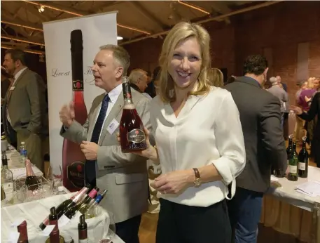  ?? JOHN W. HESSION ?? A TOAST: Cristina Mariani-May, president and CEO of Banfi Vintners, displays one of her company’s wares at last year’s New Hampshire Wine Week.