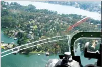  ?? The Sentinel-Record/Grace Brown ?? BIRD’S EYE VIEW: Lake Hamilton, left, as seen from the nose of the 1944 B-17 bomber Sentimenta­l Journey as it flies over the city on Monday.