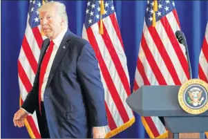  ?? AP PHOTO ?? President Donald Trump walks away after commenting on the ongoing situation in Charlottes­ville, Va., Saturday, at Trump National Golf Club in Bedminster, N.J.