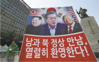  ?? Ahn Young-joon / Associated Press ?? A banner showing North Korean leader Kim Jong Un (left), South Korean President Moon Jae-in and President Trump hangs in Seoul in support of nuclear talks among their nations.