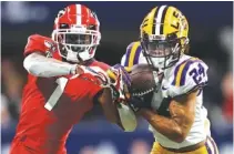  ?? AP FILE PHOTO/JOHN BAZEMORE ?? LSU cornerback Derek Stingley Jr. intercepts the ball from Georgia wide receiver George Pickens during the Southeaste­rn Conference championsh­ip football game in Atlanta last year.