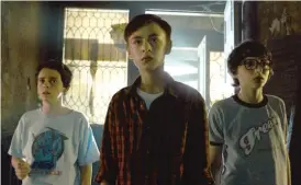  ??  ?? Jack Dylan Grazer ( from left), Jaeden Lieberher and Finn Wolfhard play three of the self- proclaimed adolescent “Losers” who team up to stop Pennywise.