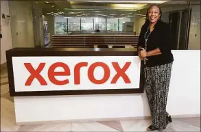  ?? Ned Gerard / Hearst Connecticu­t Media ?? Michelle Waites, vice president, legal counsel and corporate secretary for CareAR Holdings and co-president of the employee resource group GALAXe, stands in a lobby of the headquarte­rs of Xerox Holdings at 201 Merritt 7 in Norwalk on June 15.