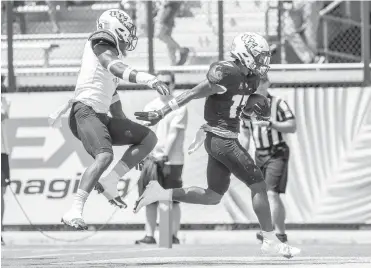  ?? WILLIE J. ALLEN JR. / ORLANDO SENTINEL PHOTOS ?? UCF receiver Amari Johnson reaches the end zone during Saturday’s spring game at the Bounce House. He finished with four catches for 66 yards and two touchdowns.