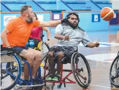  ??  ?? TACTICS: Stevin Creeggin passes in front of Daniel Donahue during the Cairns Hoopsnakes training session.