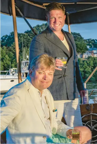  ?? COURTESY PHOTOS ?? George Reginald Oliver Molyneux Herbert, 8th Earl of Carnarvon, seated, shares a drink with Highclere Castle Gin CEO Adam von Gootkin. The company this month is introducin­g the King Charles Cocktail.