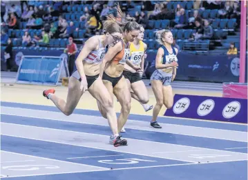  ??  ?? Photo finish Perth sprinter Lois Garland (orange vest) was in fine form at the Scottish U20 Championsh­ips and claimed silver medals in both the 60m and 200m. Photo: Bobby Gavin/Scottishat­hletics