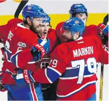  ?? CHRISTINNE MUSCHI ?? Montreal Canadiens’ Andrei Markov, right, is congratula­ted after scoring his second goal against Ottawa on Saturday.