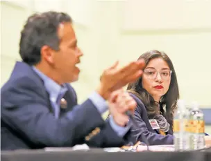  ?? GABRIELA CAMPOS THE NEW MEXICAN ?? Andrea Romero listens to Rep. Carl Trujillo while he answers a question from the audience Monday at Pojoaque Middle School during a forum for the candidates seeking the Democratic nomination for state House District 46.