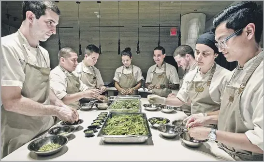  ?? Kirk McKoy Los Angeles Times ?? SOMNI’S kitchen staff prepares a dish for a 10-person-maximum seating. The cooks will serve the course to guests, and one will deliver a soliloquy of sorts about it.