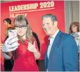  ??  ?? Sir Keir Starmer poses for a photo with a supporter during his leadership campaign