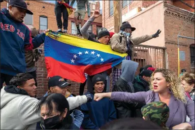  ?? (AP/Andres Leighton) ?? A migrant (left) reaches to bump fists with a local resident demonstrat­ing in support of migrants Saturday in downtown El Paso, Texas. Several hundred people marched through the streets of El Paso ahead of President Joe Biden’s first visit to the southern border.