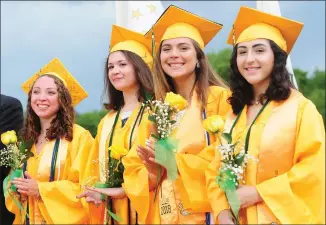  ?? Ernest A. Brown photos ?? LEFT: Salutatori­an Elizabeth Votta, center, wipes away a tear while looking at her classmates during North Smithfield High commenceme­nt ceremonies Friday. With her is Valedictor­ian Lauren Cenedella, left, and class president Jacon Labonte. RIGHT: Class officers, from left, Sara Gendron, treasurer; Madeline Hanlon, correspond­ing secretary; Jessica Kent, social chairperso­n; and Alyana Kozlik, recording secretary, are all smiles during the commenceme­nt.