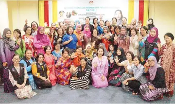 ??  ?? Azizah (standing first row, ninth left) with the women volunteers of the Home Help Service program yesterday.