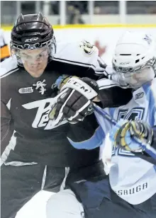  ?? CLIFFORD SKARSTEDT/EXAMINER FILES ?? Peterborou­gh Petes defenceman Jamie Doornbosch, left, locks elbows with Mississaug­a St. Michael's Majors' David Corrente during Ontario Hockey League action at the Memorial Centre on March 6, 2010. Doornbosch signed this week to play for the American...