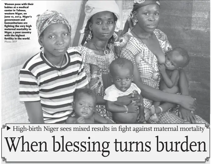  ?? Photo: AFP ?? Women pose with their babies at a medical center in Tahoua, western Niger, on June 12, 2014. Niger’s government and humanitari­ans are fighting the very high maternal mortality in Niger, a poor country with the highest fertility in the world.