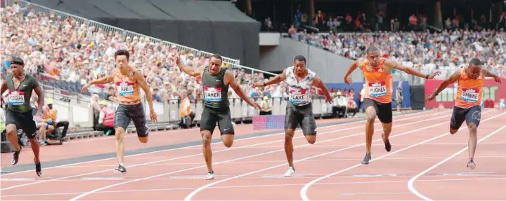  ?? — Reuters ?? Ronnie Baker of the US wins the men’s 100m final with Britain’s Zharnel Hughes finishing second and South Africa’s Akani Simbine finishing third at the London Diamond League.