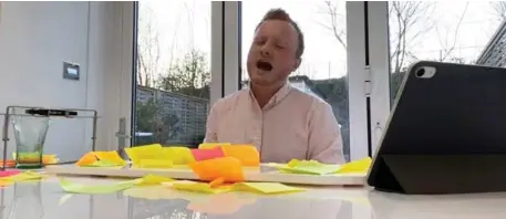 ??  ?? South Kerry musician, Jack Patrick Healy, pictured during one of his Facebook live streams that he has taken to performing during the strict COVID-19 lockdown in London. Eeach post-it note on the table is a request for a song by an audience member watching his live stream.