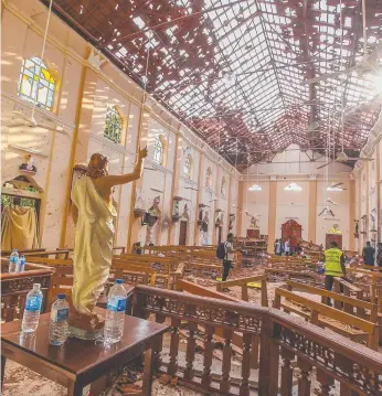  ??  ?? St Sebastian's Church in Negombo was the scene of one of the bloody attacks in Sri Lanka on Easter Sunday and (below) coffins of some of those killed in the blast. Pictures: AP PHOTO, GETTY IMAGES