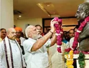  ??  ?? PM Narendra Modi paying tribute to Deendayal Upadhyay as BJP president Amit Shah looks on during the party’s 37th foundation day celebratio­ns in New Delhi on Thursday