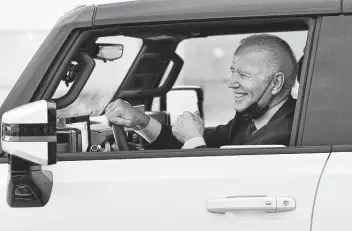  ?? Robin Buckson / Tribune News Service ?? President Joe Biden smiles after driving the GMC Hummer EV pickup at the General Motors’ Factory ZERO in Detroit on Wednesday. “That Hummer is one hell of a vehicle, man,” Biden said.