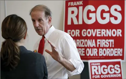  ?? ROSS D. FRANKLIN — THE ASSOCIATED PRESS ?? Republican candidate for Arizona governor Frank Riggs chats with a possible constituen­t prior to the 2014Arizon­a West Valley Republican Gubernator­ial Forum on July 16, 2014, in Glendale, Ariz.