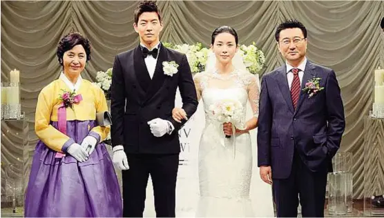  ??  ?? Social climber: a wedding scene from the popular Korean TV drama series Mydaughter­Seo-young. The title character (second from right) marries into chaebol after lying that her debt-ridden father is dead.