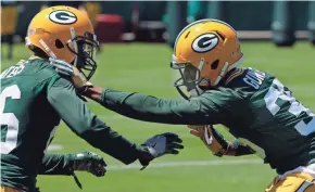  ?? / MILWAUKEE JOURNAL SENTINEL ?? Packers cornerback Herb Waters and cornerback LaDarius Gunter participat­e in drills during organized team activities in Green Bay.