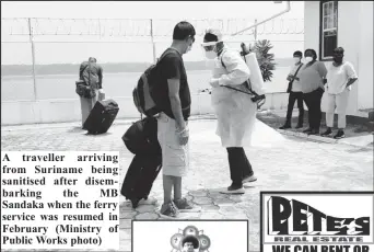  ??  ?? A traveller arriving from Suriname being sanitised after disembarki­ng the MB Sandaka when the ferry service was resumed in February (Ministry of Public Works photo)