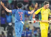  ??  ?? Yuzvendra Chahal (L) celebrates the wicket of Glenn Maxwell during the first ODI