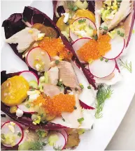  ?? KARSTEN MORAN / THE NEW YORK TIMES ?? Smoked trout and beet salad with trout roe. Humble ingredient­s can be as celebrator­y as caviar and truffles.