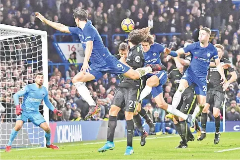 ?? — AFP photo ?? Chelsea’s Spanish defender Marcos Alonso (C) directs this header past Brighton’s Australian goalkeeper Mathew Ryan (L) to score their second goal during the English Premier League football match between Chelsea and Brighton and Hove Albion at Stamford...