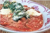  ?? ANGELA PETERSON, MILWAUKEE JOURNAL SENTINEL ?? Mezzaluna, half-moon pasta filled with braised pork and mascarpone, are served in spicy tomato sauce and topped with spinach and garlic breadcrumb­s at Brandywine.