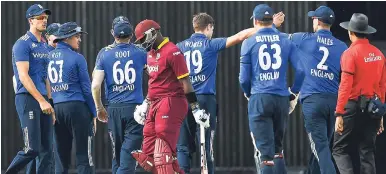  ?? WEST INDIES MEDIA ?? West Indies batsman Ashley Nurse (centre) makes his way to the Pavilion after being dismissed by England’s Chris Woakes in the third ODI between England and West Indies at Kensington Oval in Barbados. England won by 186 runs.