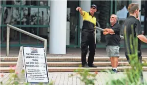  ?? CRAIG BAILEY/FLORIDA TODAY ?? A security guard directs people Monday at the entrance to Jacksonvil­le Landing, where two were killed and several wounded Sunday.